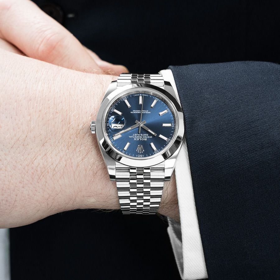 A man modeling the Rolex Datejust 41 126300 in Stainless Steel with a Bright Blue Dial