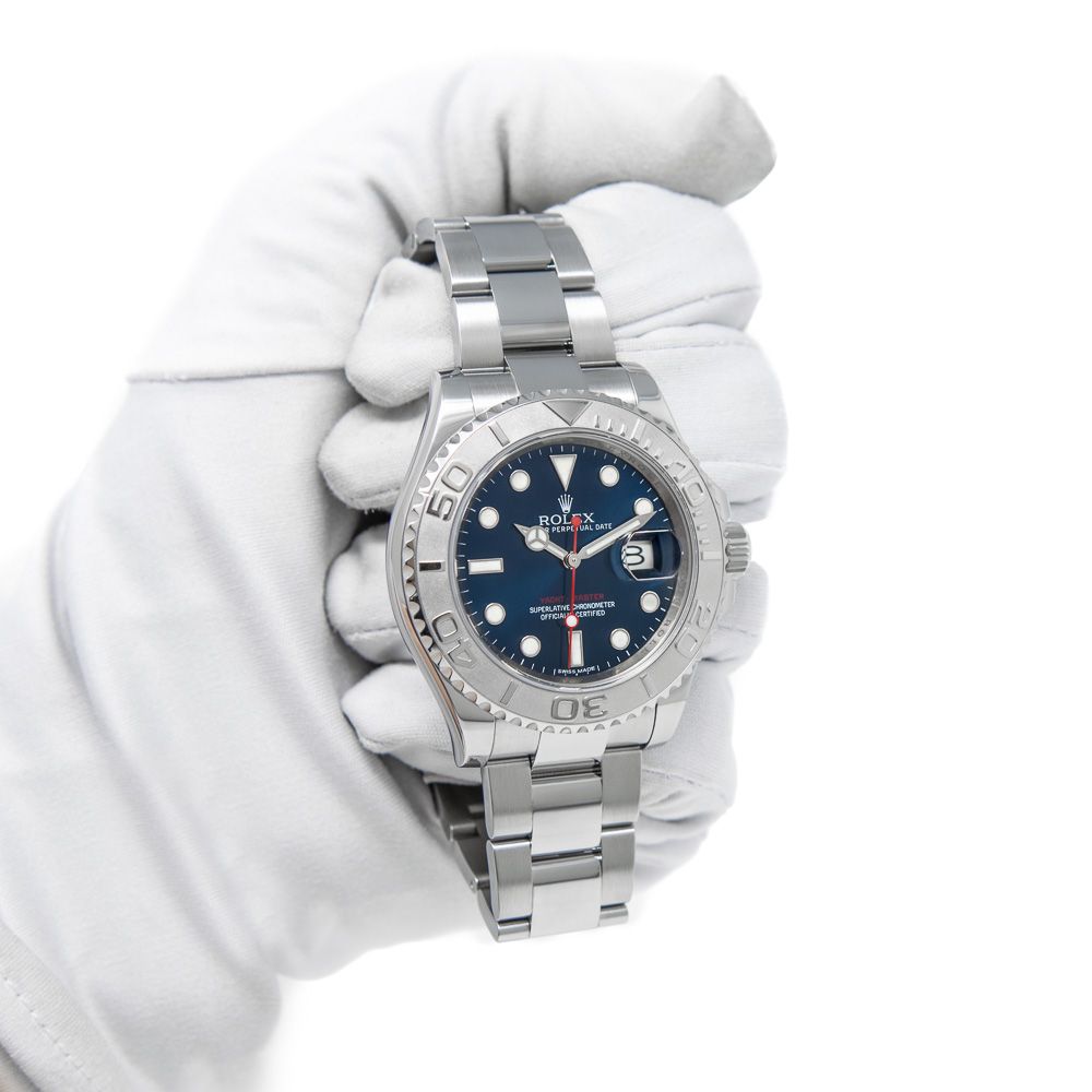 A white gloved hand holding the Rolex Yacht-Master 116622 in Steel & Platinum with a Blue Dial