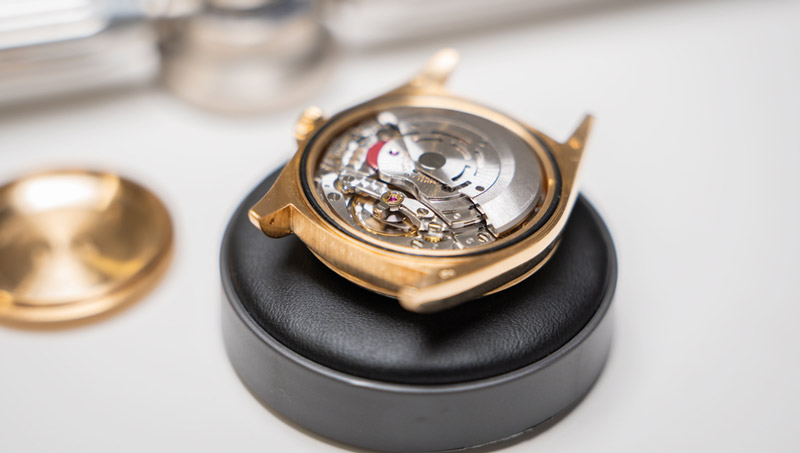 A watch open and being inspected