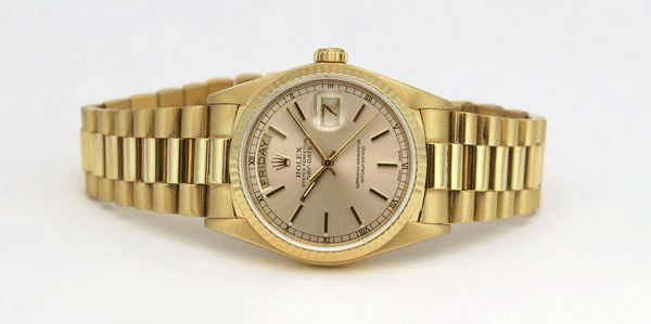 A yellow gold Rolex Day-Date 18238 President Champagne Index on a white surface